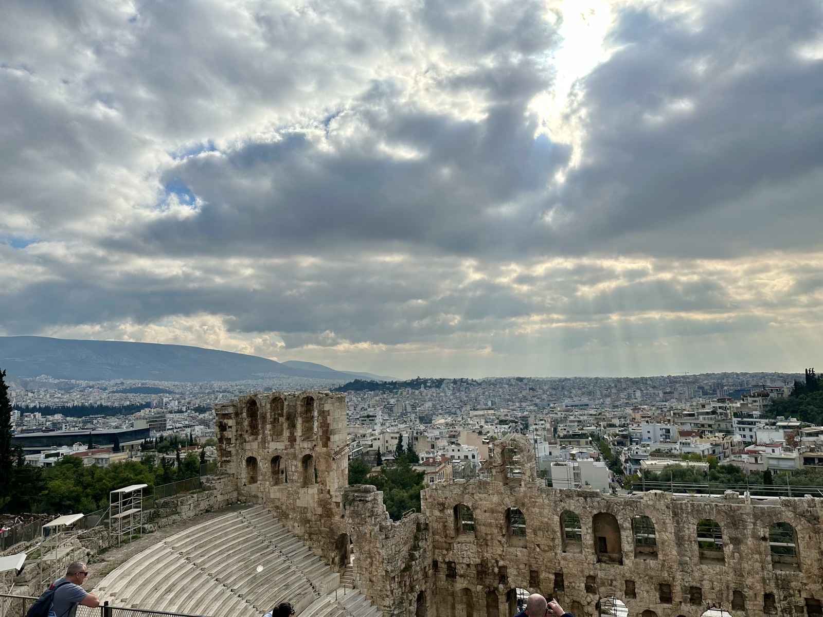 The ancient Odeon of Herodes Atticus below the Acropolis, under dramatic clouds