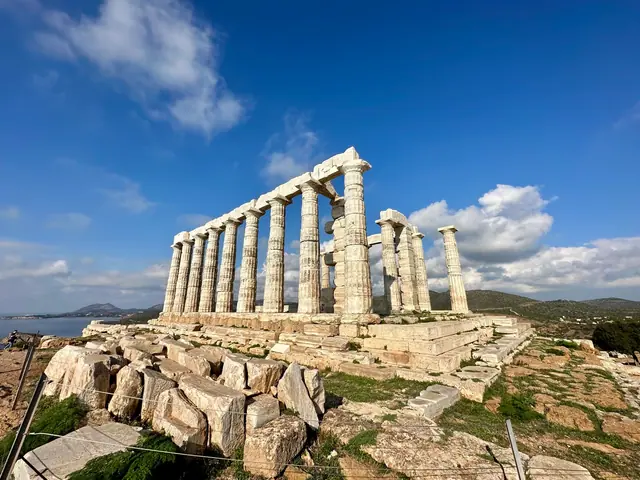 The Temple of Poseidon at Cape Sounion, Greece, under a bright blue sky