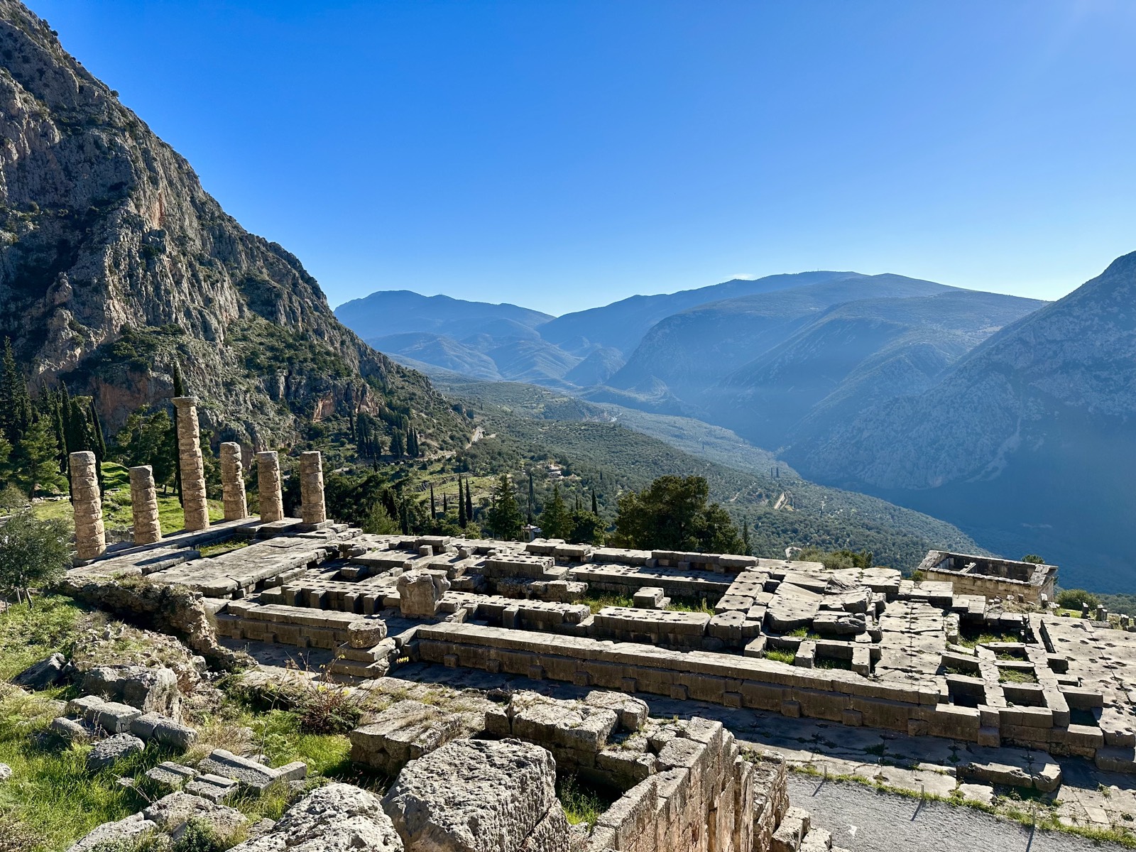 The Temple of Apollo at Delphi overlooking a valley of olive groves