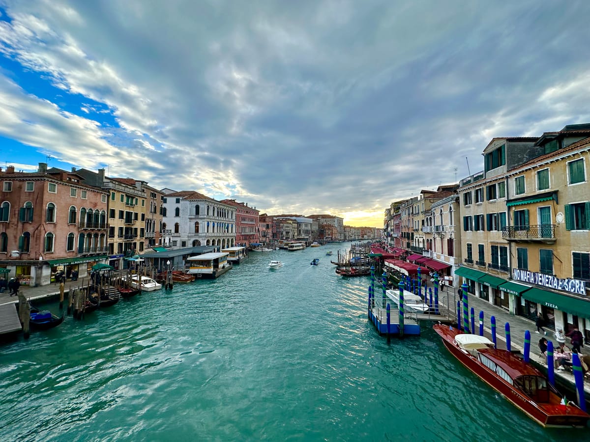 A view of the Grand Canal at sunset seen from the Rialto Bridge in Venice, Italy.