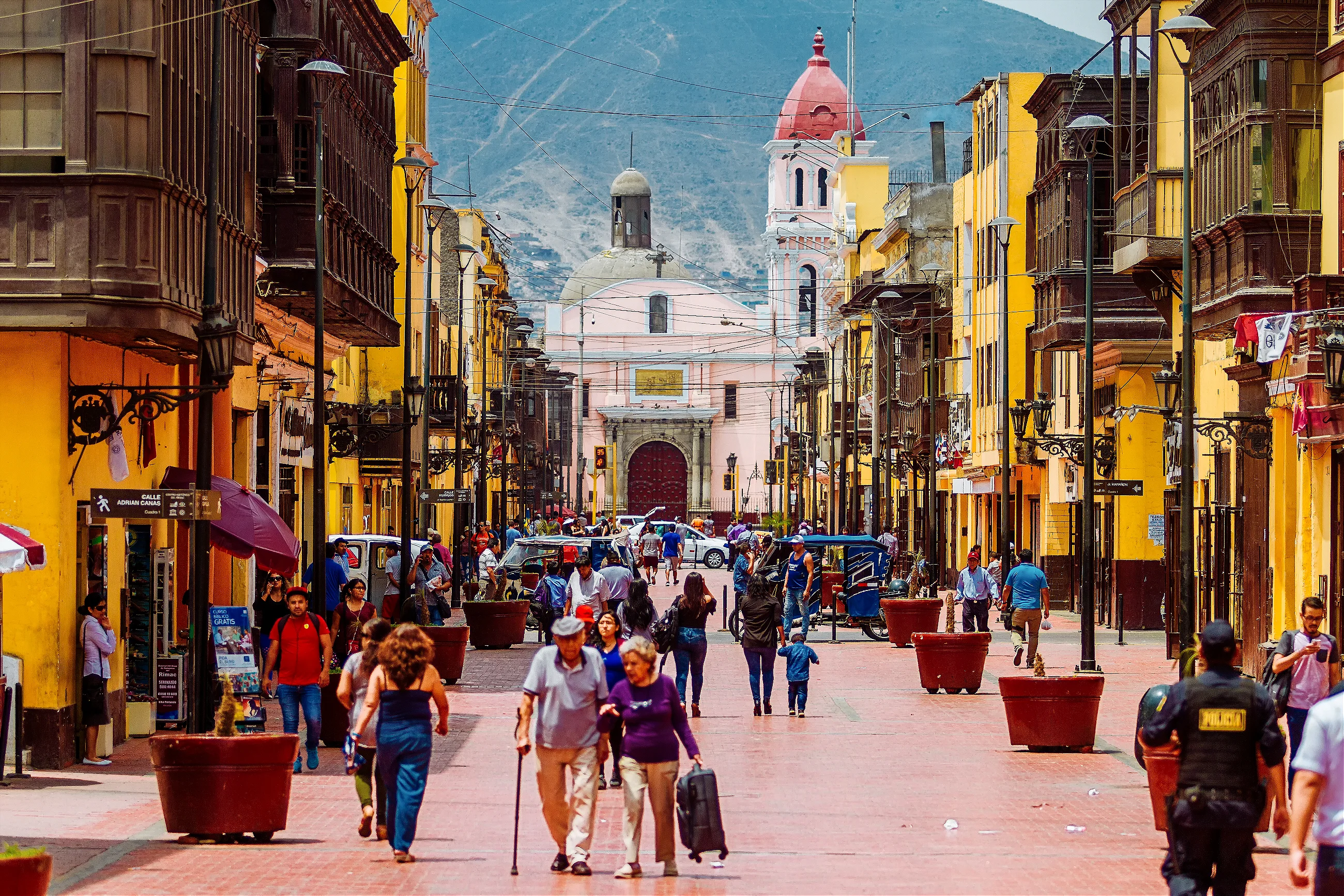 Pedestrians on a colorful historic street in Lima, Peru